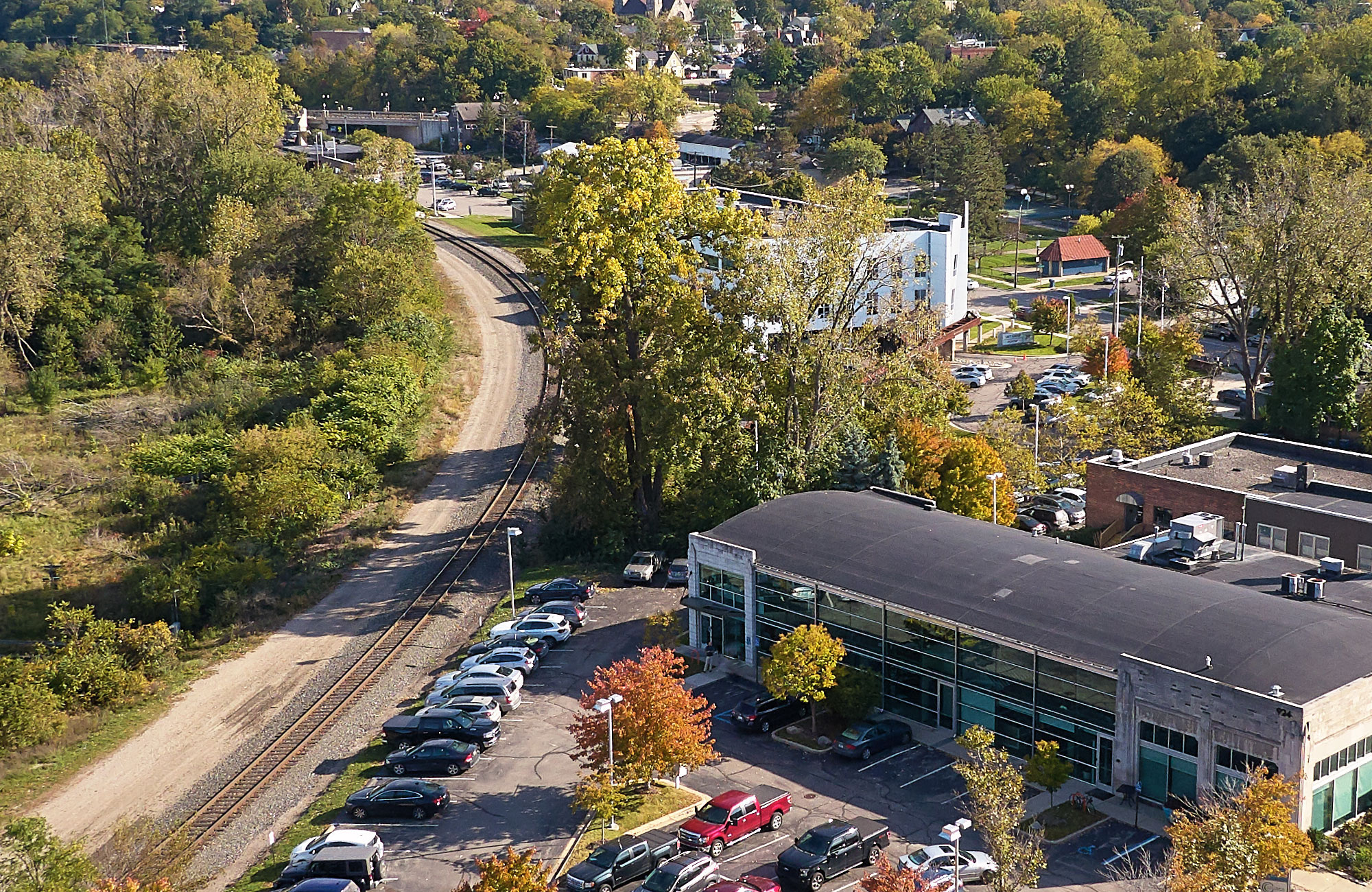 Columbia Asset Management office by train tracks, cars in parking lot, and Ann Arbor trees